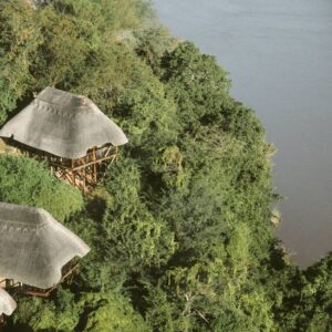 Thatched cliff-edge chalets of Chilo Gorge Safari Lodge above the Save River, Gonarezhou, Zimbabwe