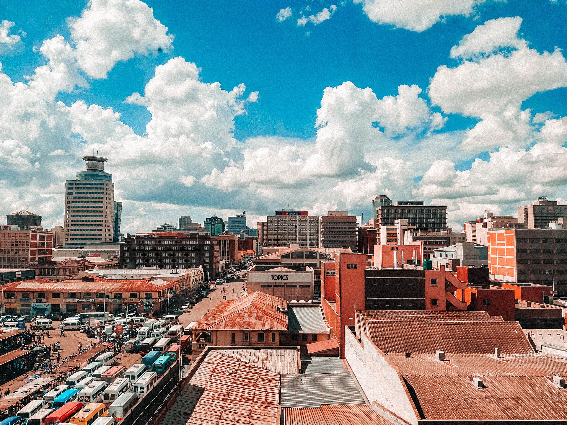 Office blocks and streets in central Harare under a cloudy sky