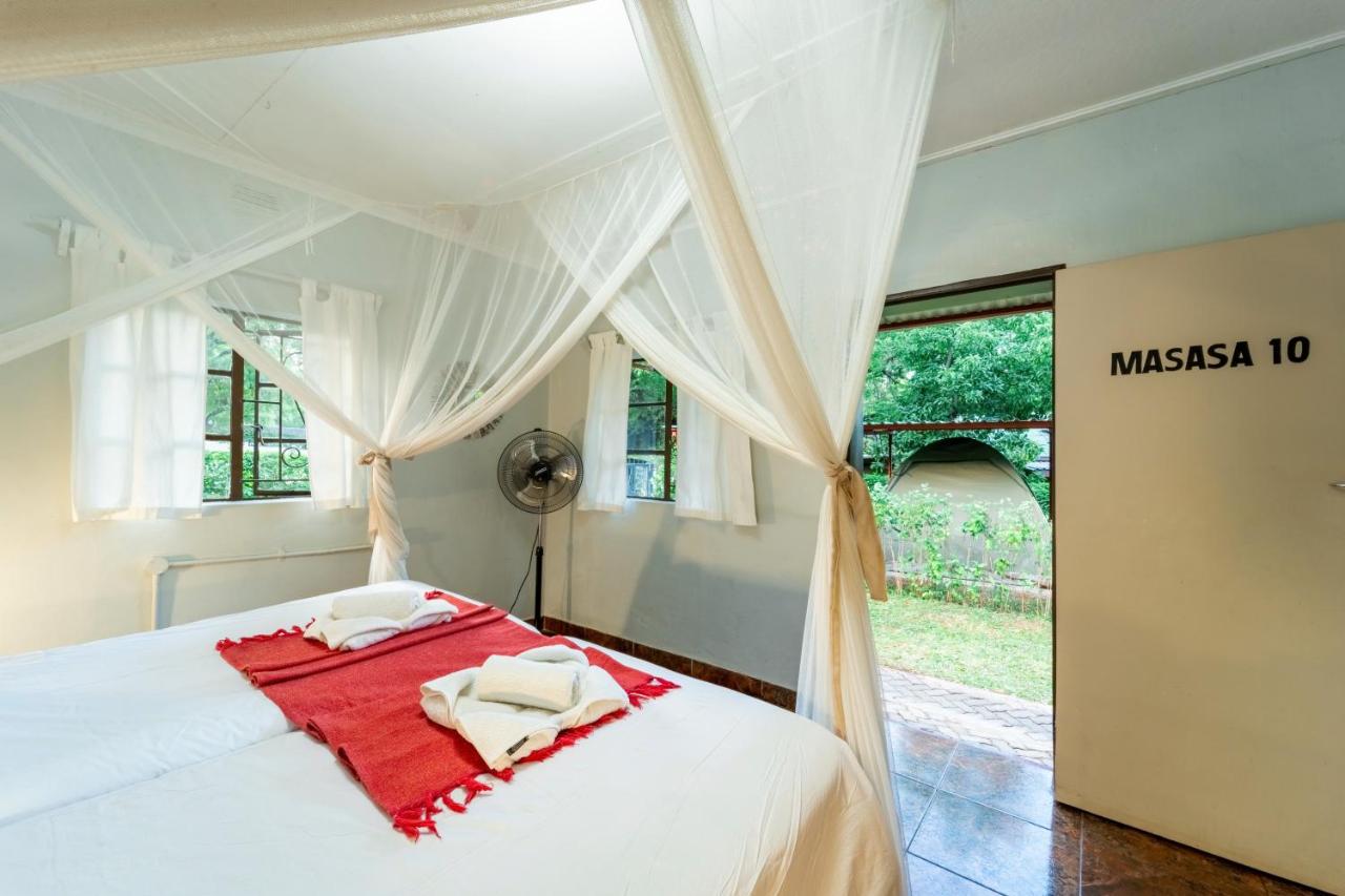 A private room at Shoestrings Backpackers Lodge with a mosquito net over the bed