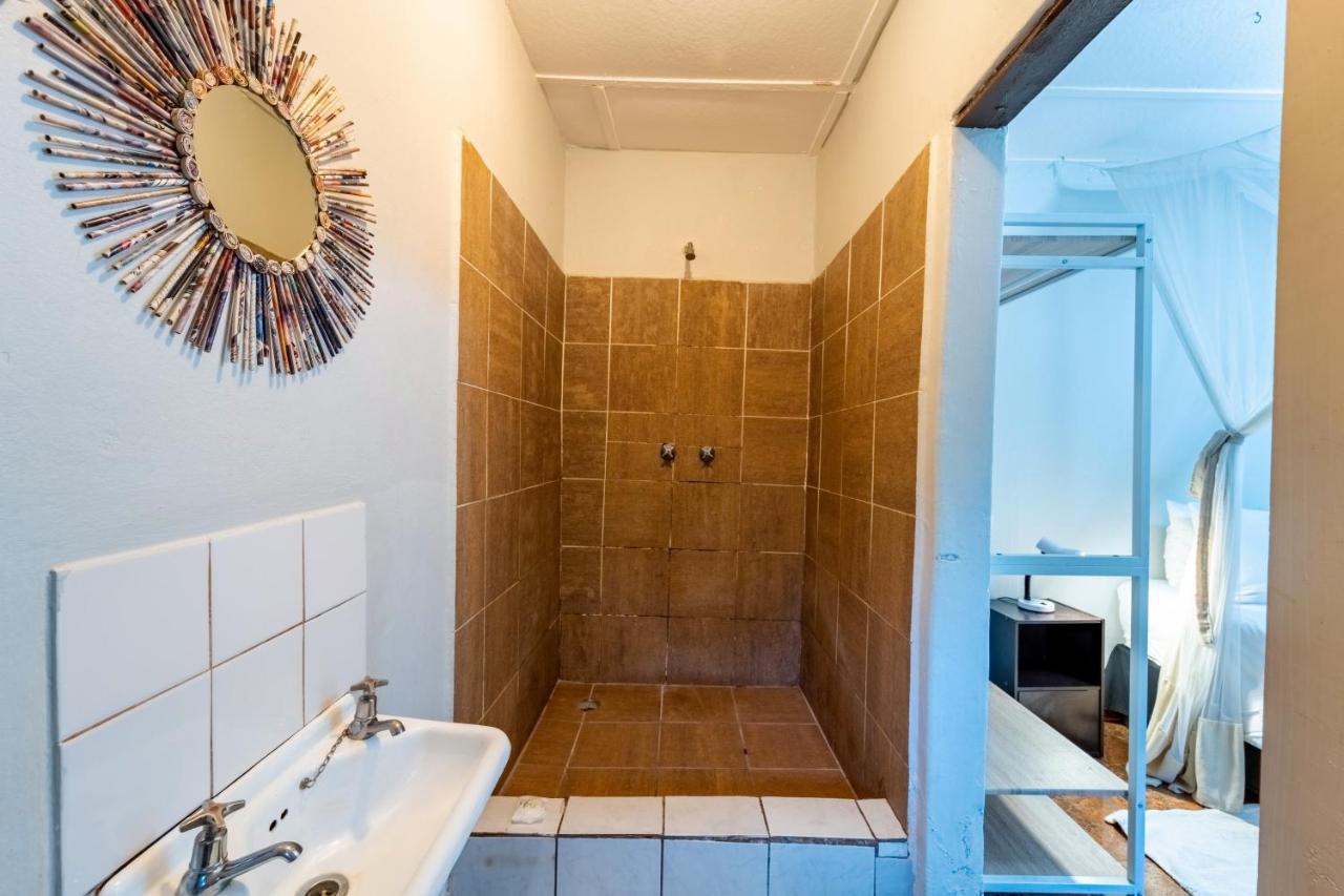 A tiled shower room and basin in one of the private rooms